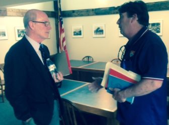 Judge Edwin Kelly, administrator of the District Courts, left, speaks with Thomas McCarthy, who complained about the family court system at a meeting on Wednesday.