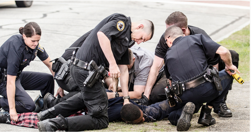 Officers placing Anthony Maldonado under arrest after he allegedly punched an officer who was pursuing him as a suspect for suspicious activity.