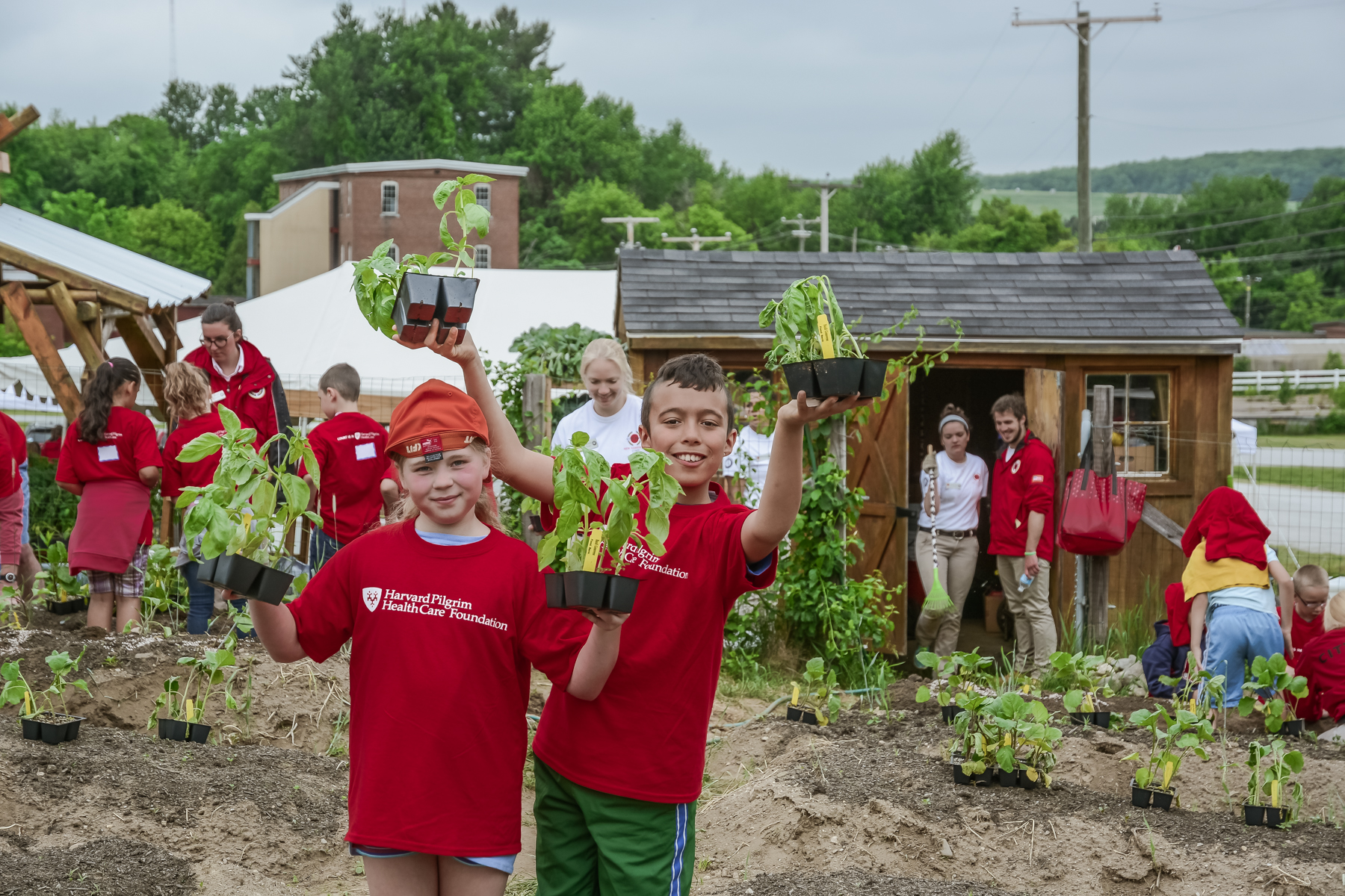Kaelin Robidas (left) and Manuel Paradis-Rosas, both 3rd graders at Hallsville School in Manchester, helped plant basil plants in the NH Food Bank’s Production Garden in Manchester as part of Harvard Pilgrim Health Care’s 8th annual Day of Service. 