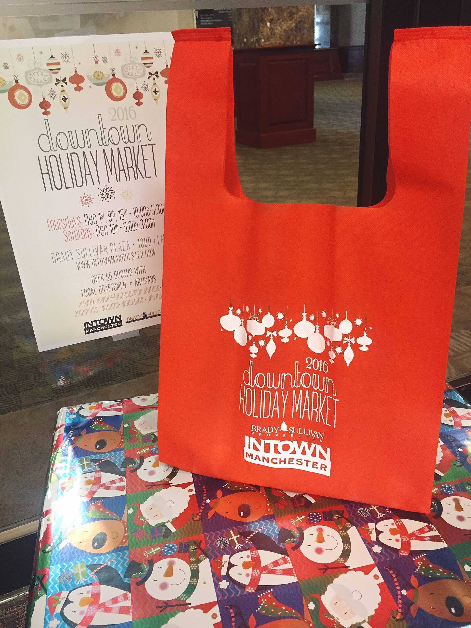 Get your exclusive "holiday tote bag" so you can fill it with goodies from Intown Manchester's Holiday Market.