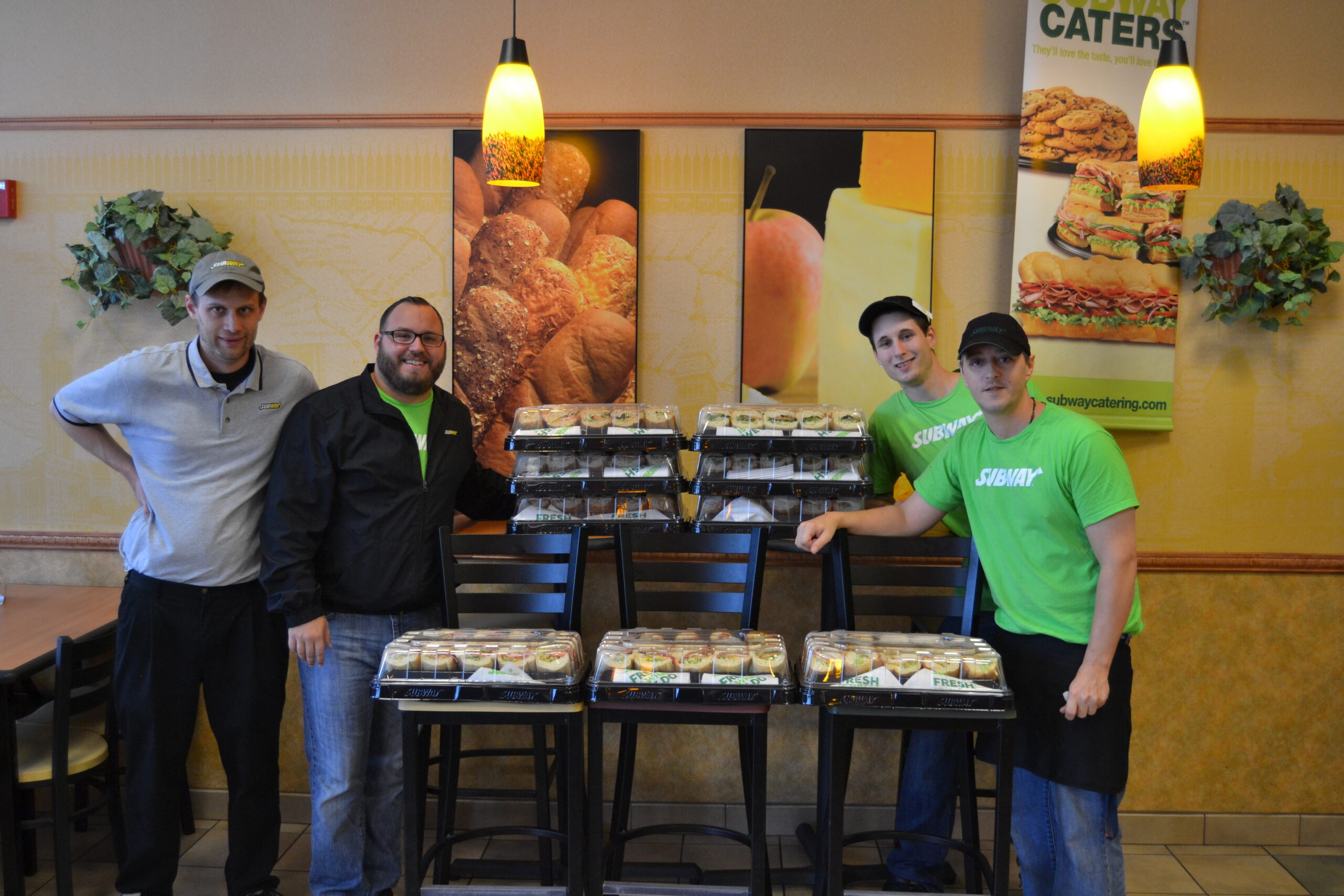 Dave Beckwith, Franchise Owner and Development Agent, Seth Hallett, Director of Operations for the State of New Hampshire, and staff at SUBWAY on Valley Street in Manchester.