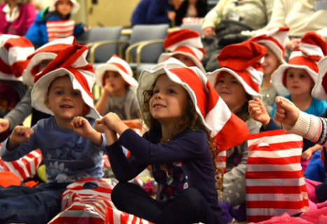 Children from Elliot Child Care Center dancing along. 