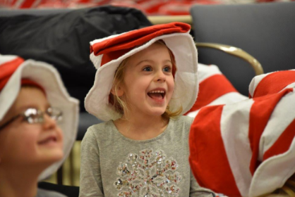 Emilie Rourke is all smiles listening to the  Reach Out and Read presentation at Elliot Hospital.