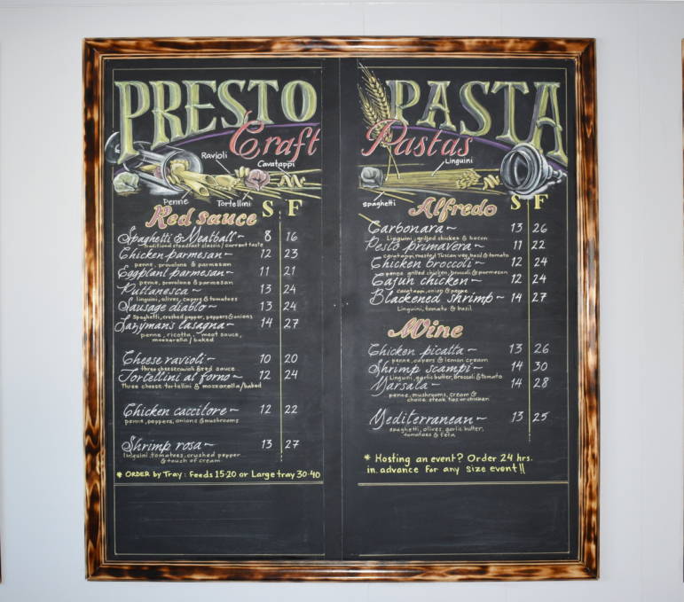 Hand lettered menu board at Presto Pasta