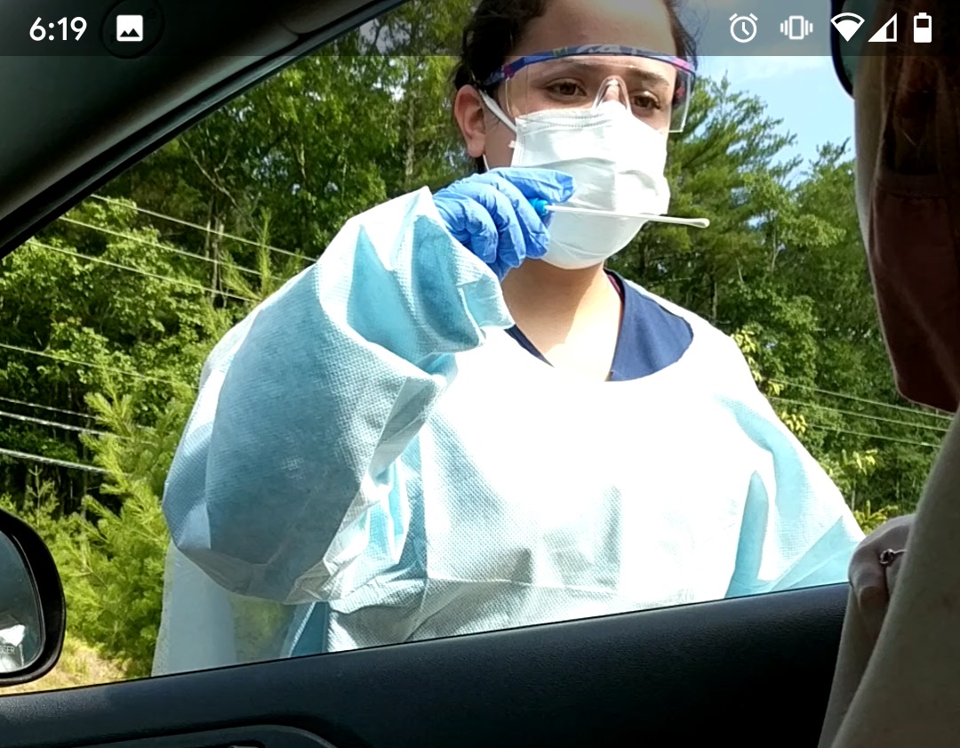 A medical professional performs a COVID-19 test