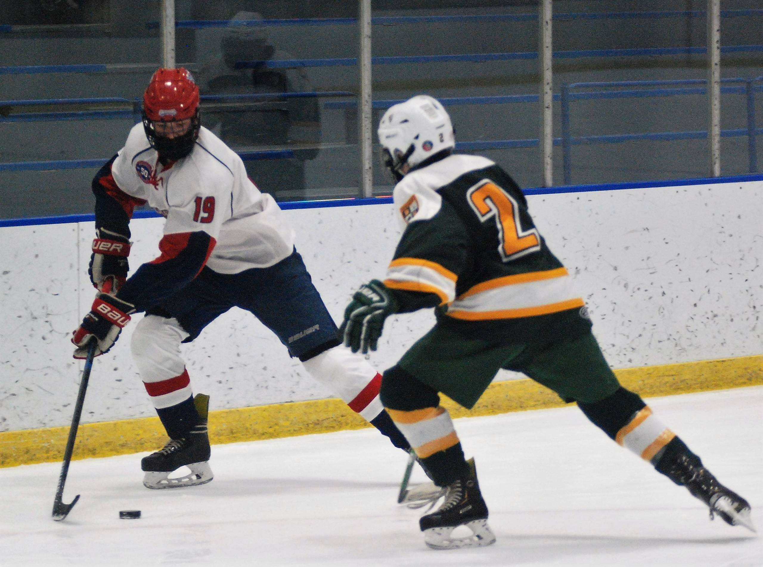 Brandon Murphy corraling the puck near the boards.