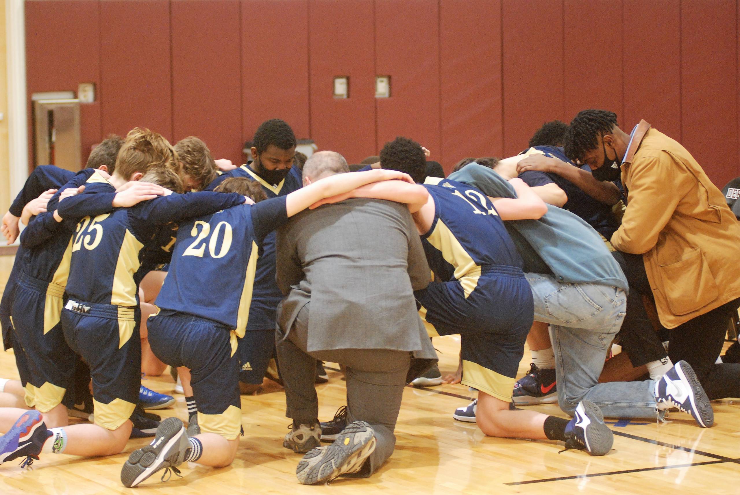 Holy Family players praying.