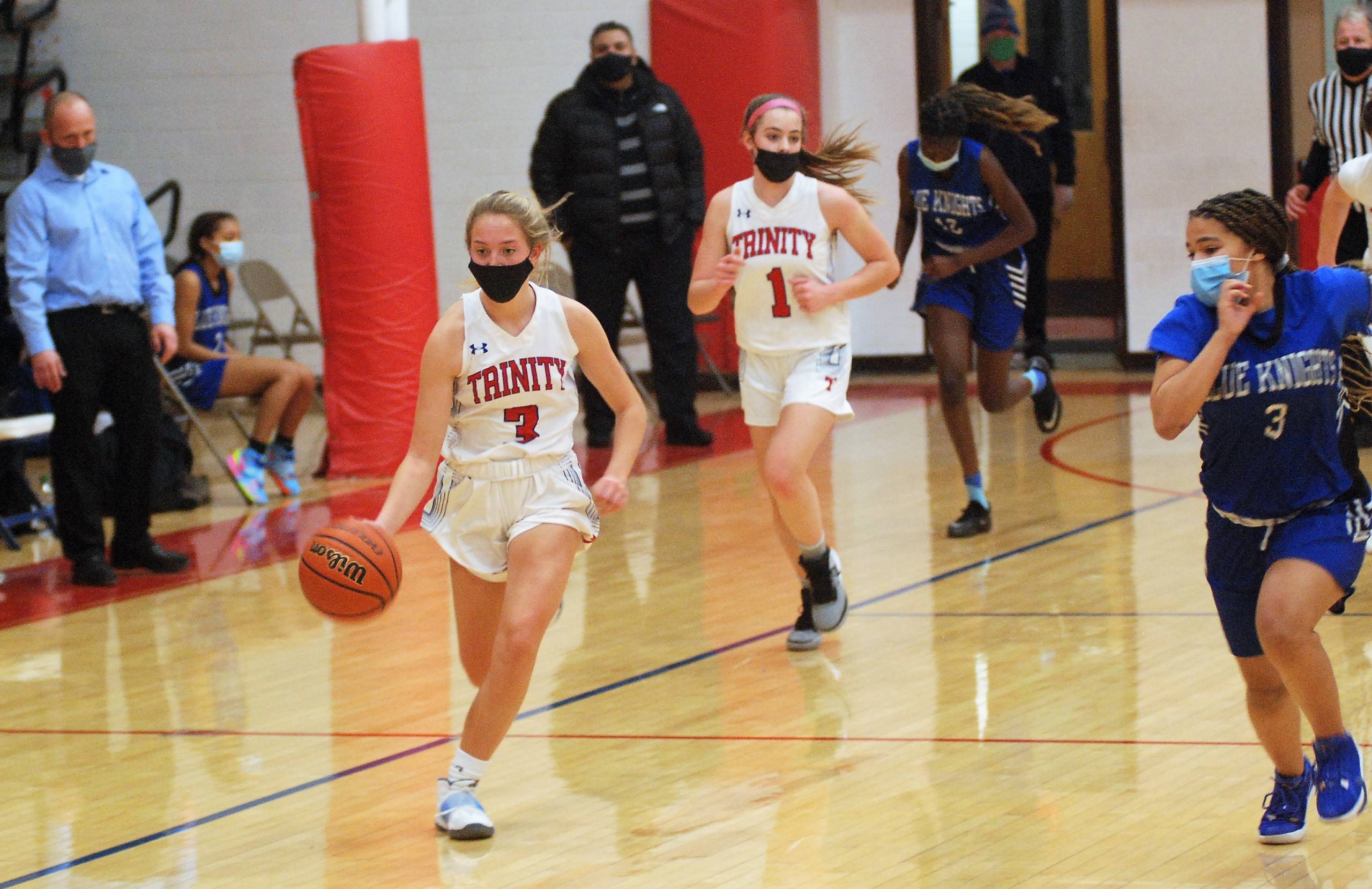 Devan Booth dribbling with Dakota Correua running behind her.