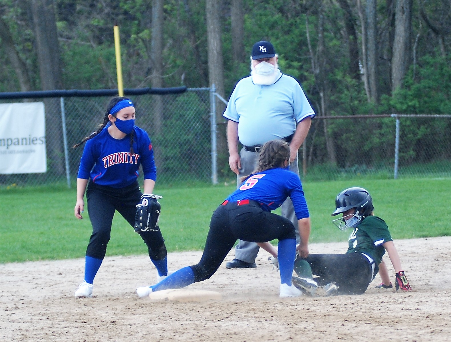 Trinity shortstop Emma Service tags Central's Catherine Jones for the out.