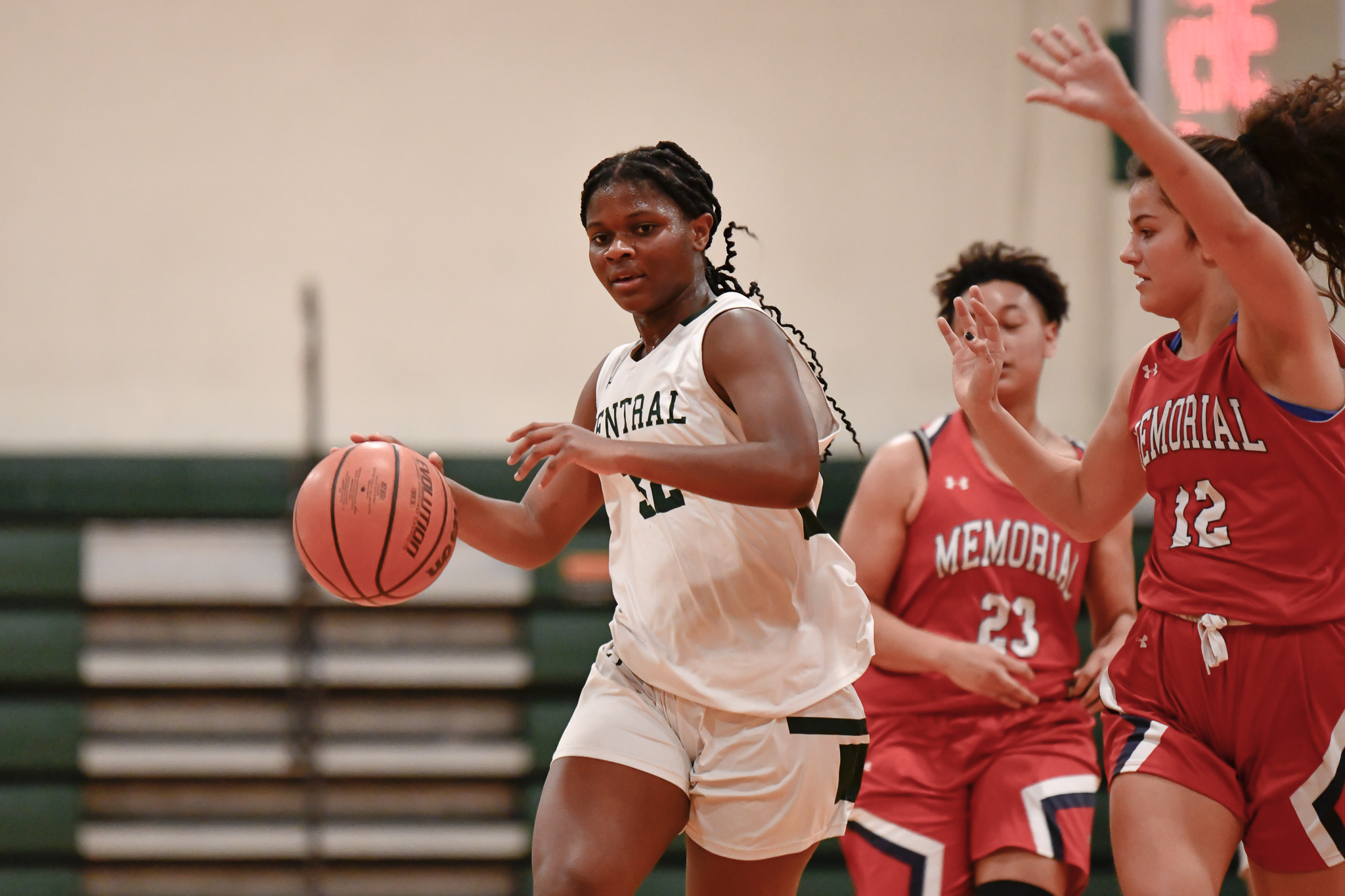 Manchester Central's Sylvie Bangasimbo drives in on Memorial's Marlaina Schmitt.