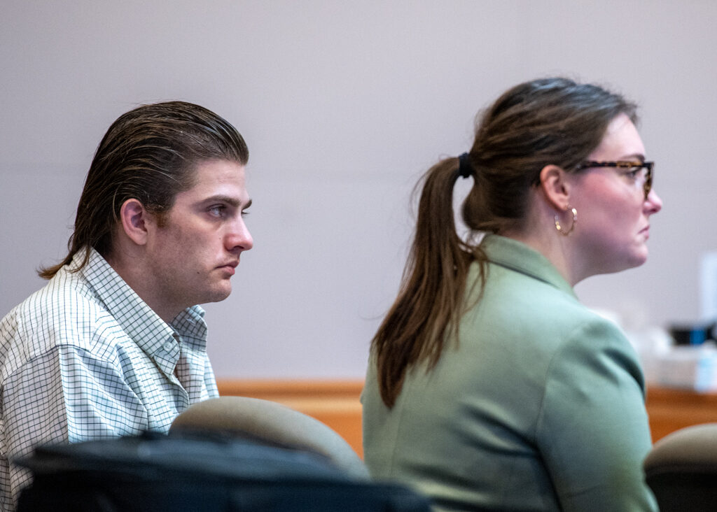 Eric Earle, left, sits next to one of his public defenders in court. Earle was found not guilty. Photo/Jeffrey Hastings