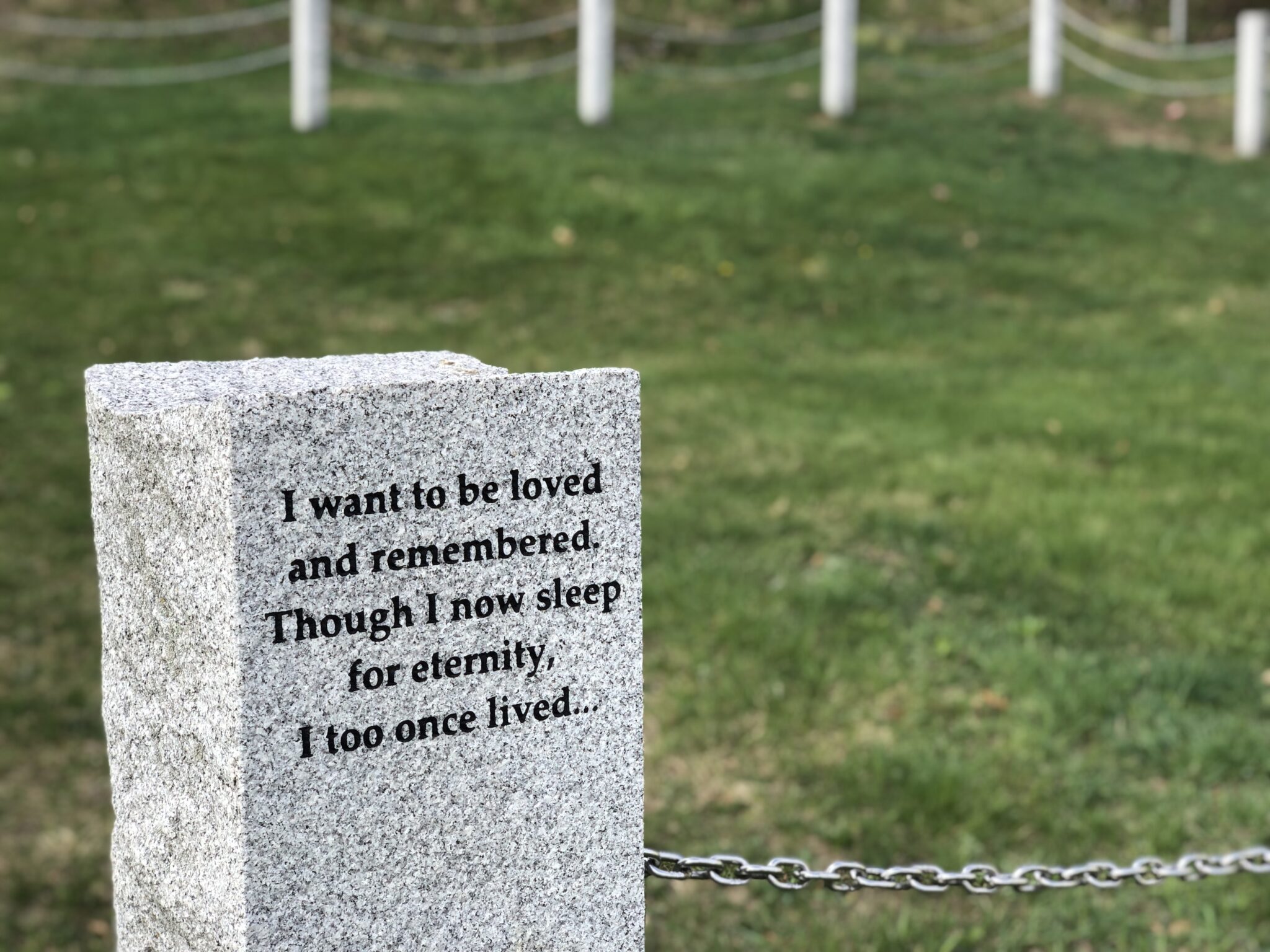 Next to an old ball field on Pleasant Street in Concord are unmarked graves of New Hampshire Hospital patients who died without anyone to claim them. (Hadley Barndollar | New Hampshire Bulletin)