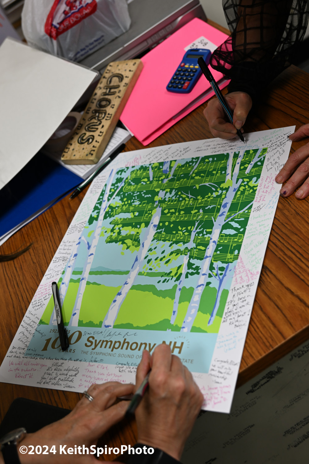 All hands signing the poster. Photo by Keith Spiro