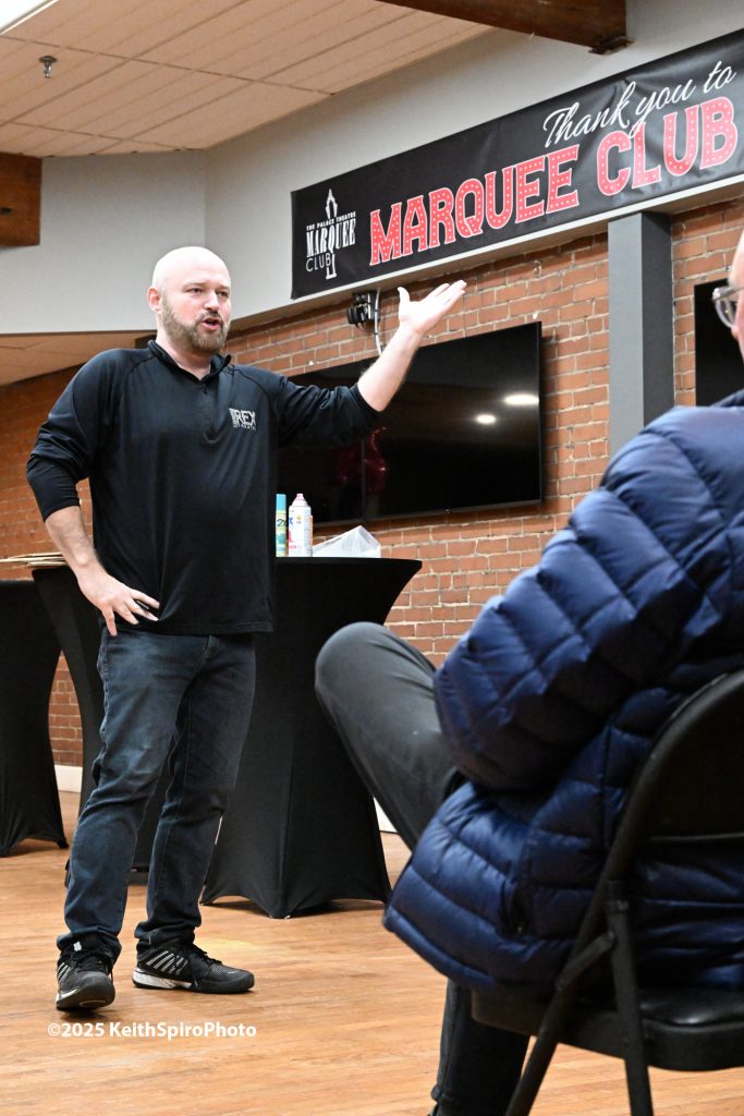 Marquee club photo by Keith Spiro shows Carl Rajotte answering questions from members.