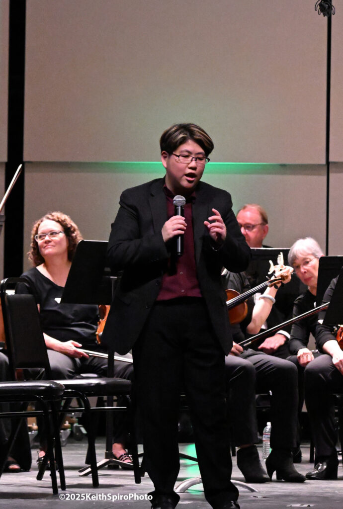 SymphonyNH guest conductor Tiffany Chang is seen, microphone in hand, talking to the audience in this Keith Spiro Photo.