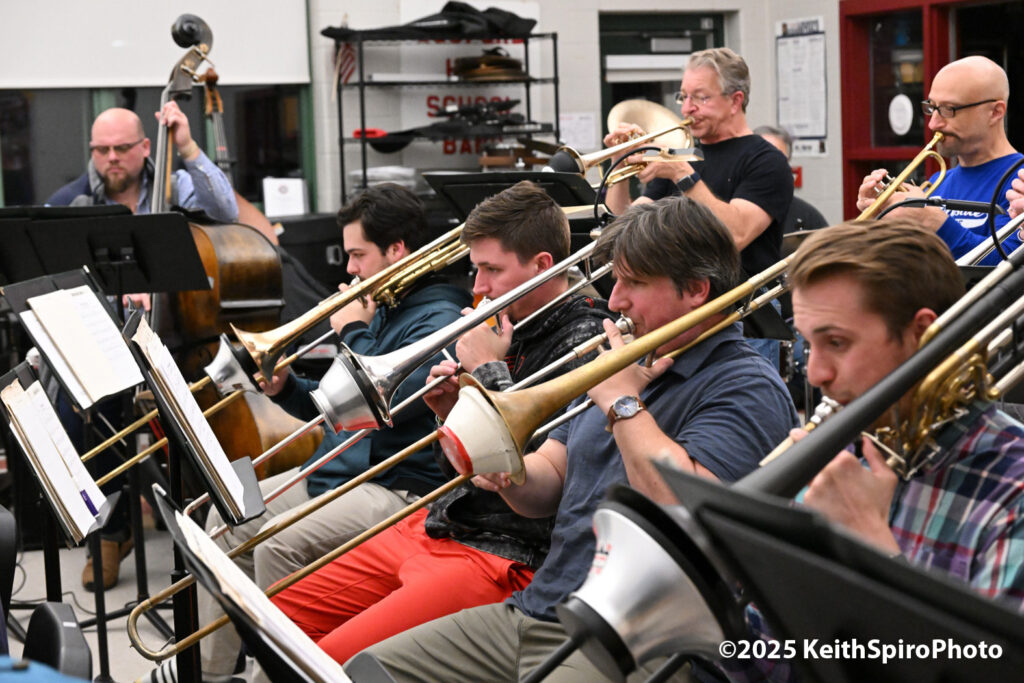 There are many ways to create a jazz laugh in this photo by Keith Spiro of the trombones and trumpets in rehearsal.