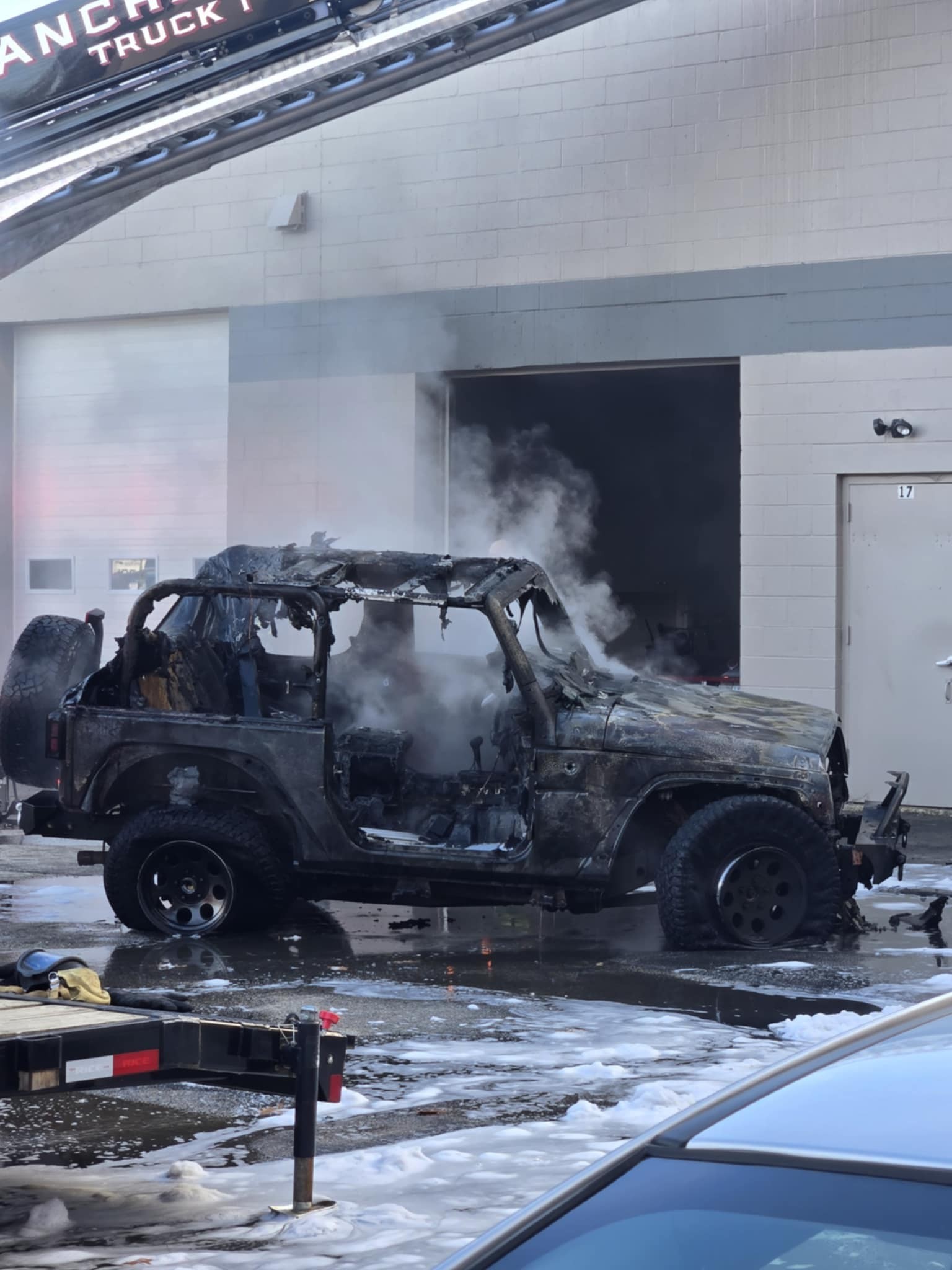 Vehicle burns in commercial garage fire on East Industrial Drive