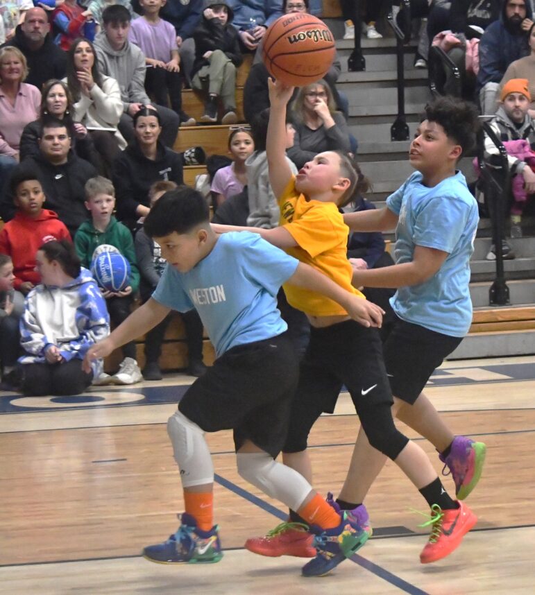 photo by Andrew Sylvia of young children playing basketball.