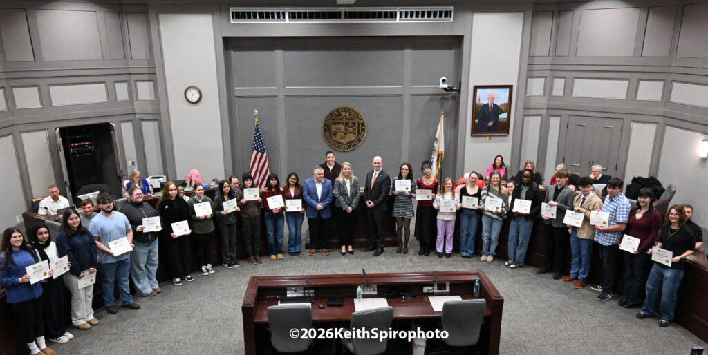 This is a photo by Keith Spiro showing City Hall Manchester Aldemanic Chambers with Mayor Ruais and all the art students that were recognized in a city hall event.